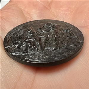 A 19th c. Large molded black horn button of FOP couple.