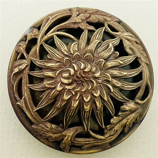 Highly sculptural brass button of a chrysanthemum.