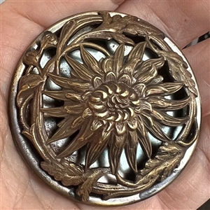Highly sculptural brass button of a chrysanthemum.