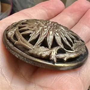 Highly sculptural brass button of a chrysanthemum.