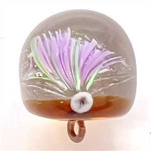Glass paperweight studio button by Mary Gaumond of a thistle.