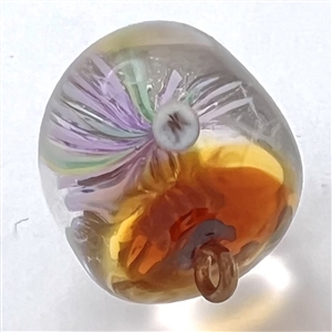 Glass paperweight studio button by Mary Gaumond of a thistle.