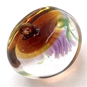 Glass paperweight studio button by Mary Gaumond of a thistle.