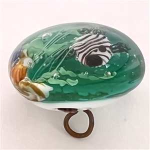 Glass paperweight studio button of fish swimming.