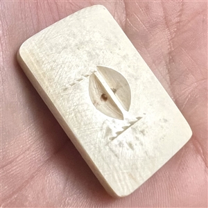 Scrimshaw on natural material button of a cobra snake.