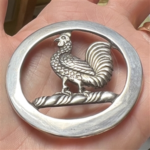White metal Livery trim of a rooster.