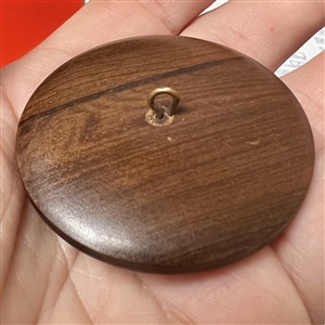 A 19th c Brass Prince of Wales feathers engorged by a crown over wood button.