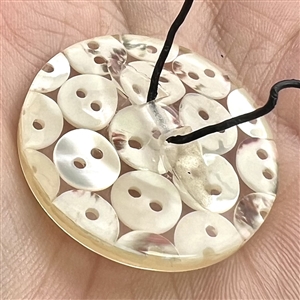 Tiny pearl buttons encased in acrylic button.