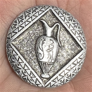 Aluminum button of a vase.