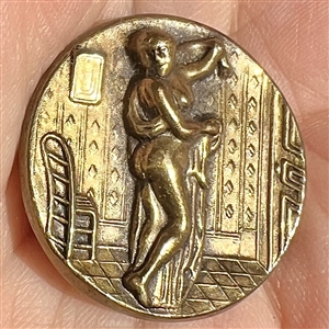 “After the bath” brass button of woman.