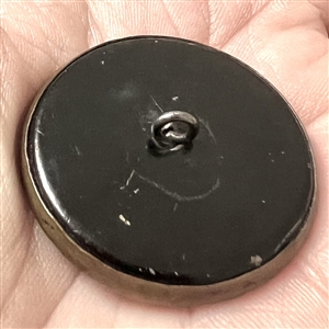 Victorian celluloid button set in tinted brass with flowers and lace.