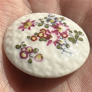Transitional Mennecy ceramic button of flowers.