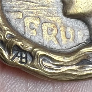 Art Nouveau brass button of a woman with verbal “Terre (earth) by Armond Bargas.