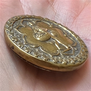 Unusual brass button of a man carrying baskets.