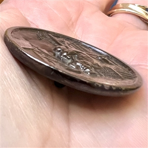 “Sleeping watchman” tinted brass button.