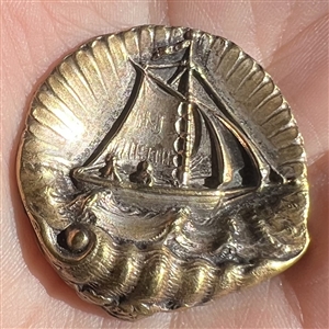“Sailboat in a Shell” brass button.