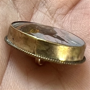 Reverse-painted architectural scene under glass set in gilded metal button.