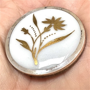 A 19th c. Gold luster painted carnation on white ceramic button.