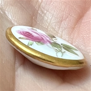 An 18th c. Dresden porcelain button of a rose.