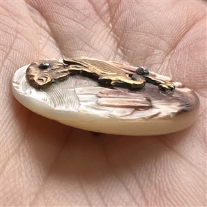 Cameo carved pearl button with cattails and brass heron with fish.