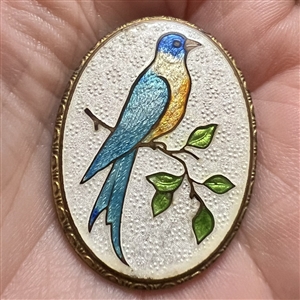 Basse-taille enamel button of a blue bird on a branch.