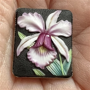 Japanese Arita porcelain button of an orchid set in sterling silver.
