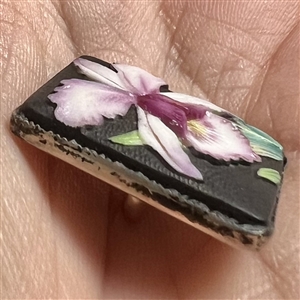 Japanese Arita porcelain button of an orchid set in sterling silver.