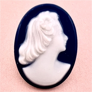 Limoges porcelain oval button of a woman’s head.