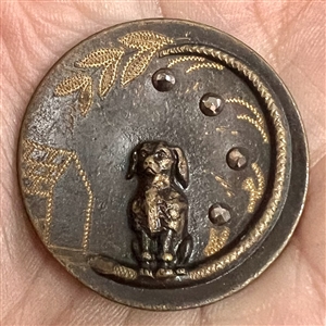Tinted brass button of a poodle.