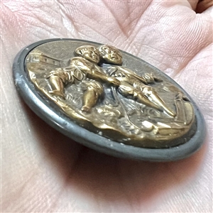 “Boating brass button of two boys playing with sailboat.