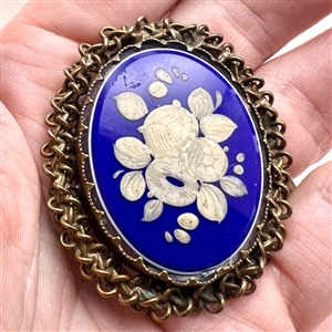 White glass and blue glass overlay set in metal button.
