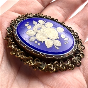 White glass and blue glass overlay set in metal button.