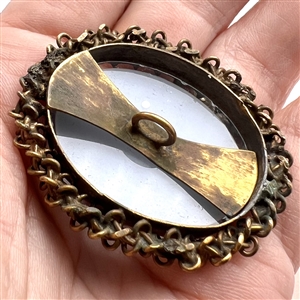 White glass and blue glass overlay set in metal button.