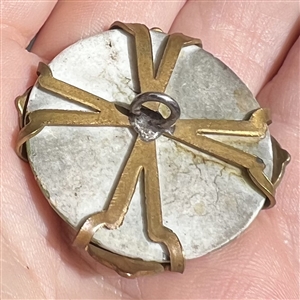 Painted porcelain button set in an unusual brass “spider.
