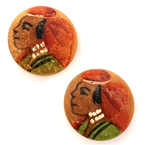 Two painted vegetable ivory buttons of heads.