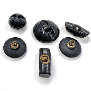 Six black glass buttons, including a tile star. 