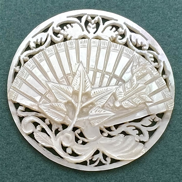 Bethlehem pearl button of a fan and flora elements.