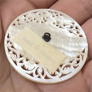 Bethlehem pearl button of a fan and flora elements.