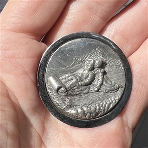 “Toboggan Ride pewter set in steel-cup button.