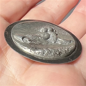 “Toboggan Ride pewter set in steel-cup button.