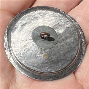 “Toboggan Ride pewter set in steel-cup button.