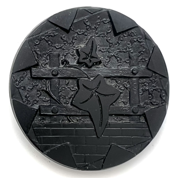 “Ivy leaves and trellis" black glass button.
