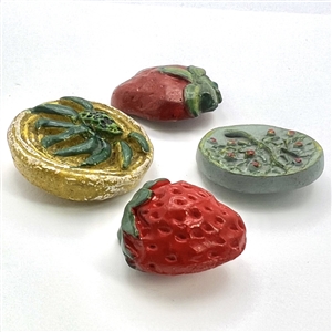 Four painted plaster buttons. 