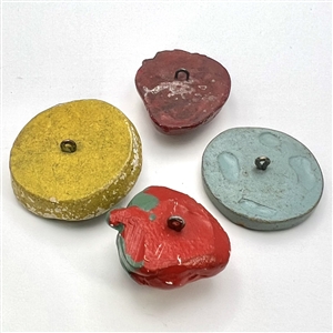 Four painted plaster buttons. 