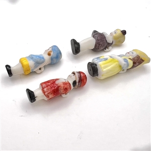 Four painted ceramic buttons of little girls.