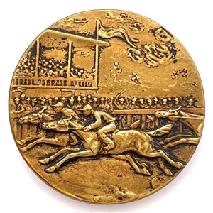 Brass button of a horse race with grandstand.