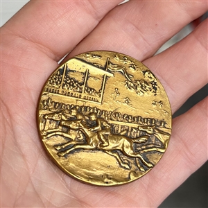 Brass button of a horse race with grandstand.