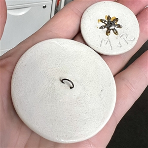 Two studio ceramic buttons of transportation. 
