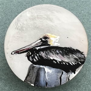 Painted shell studio button of a pelican by Clair Scott. 