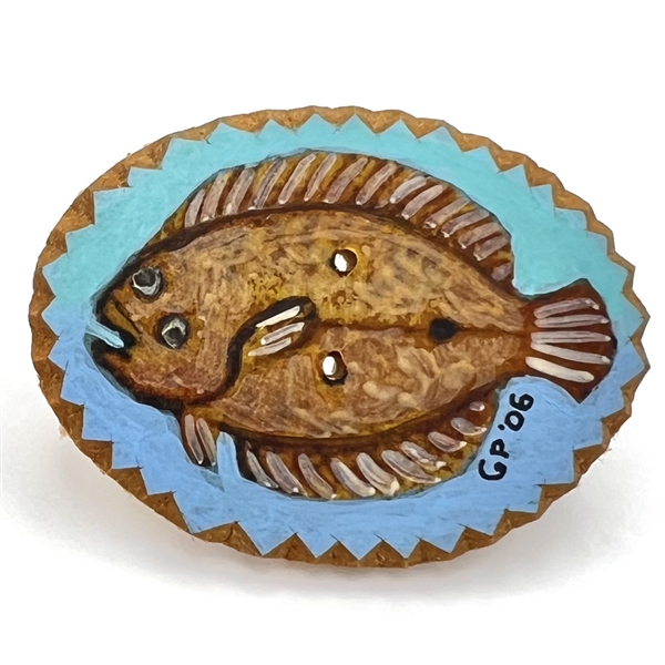 Painted masonite studio button of a flounder fish. 